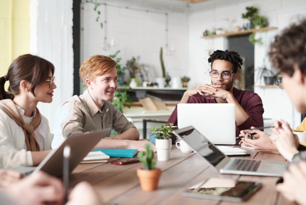 Marketing team collaborating on laptops, discussing strategies for data-driven email and ecommerce campaigns.