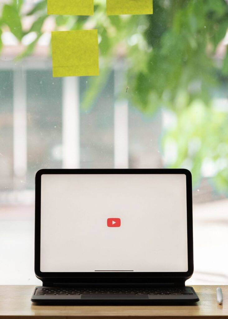 Tablet displaying the iconic red YouTube play button logo, representing expert YouTube ad campaigns and video marketing.