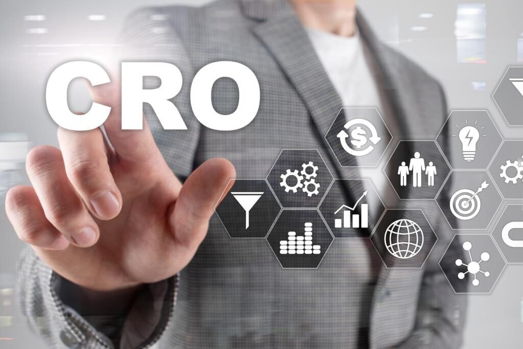 Business professional's hand interacts with 'CRO' text and digital icons for conversion funnels, analytics, and ROI, highlighting CRO audits.