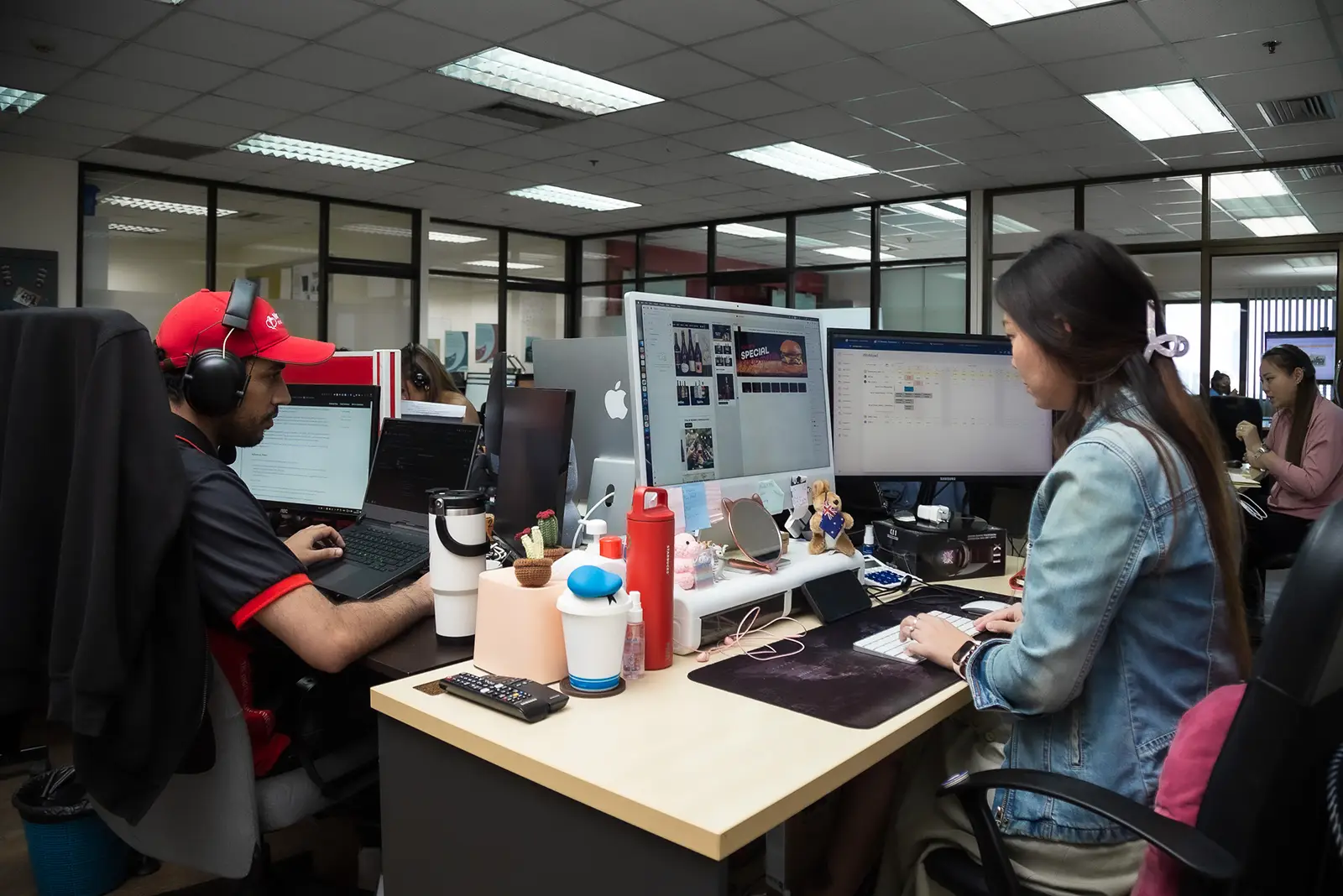 Move Ahead Media Bangkok team crafting digital marketing, SEO, and social media campaigns on multiple computer screens.