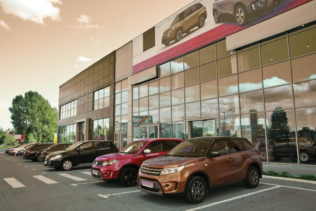 Modern auto dealership with new SUVs parked outside, symbolizing the automotive industry for digital marketing growth.