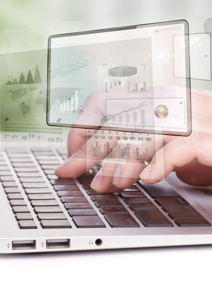 Hands typing on a laptop, with data charts and graphs overlaid, illustrating data-driven Google remarketing campaign management.