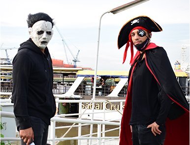 Two team members in creative costumes: Michael Myers and a pirate, reflecting Move Ahead Media's diverse, bold branding experts.