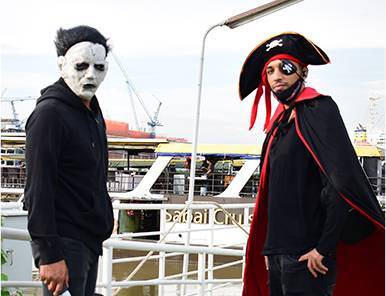 Two team members in creative costumes: Michael Myers and a pirate, reflecting Move Ahead Media's diverse, bold branding experts.