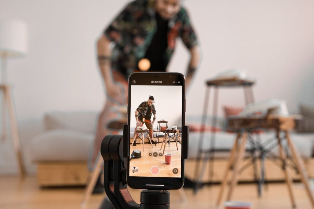Man records engaging video content on a smartphone, demonstrating creative services to elevate your digital brand.