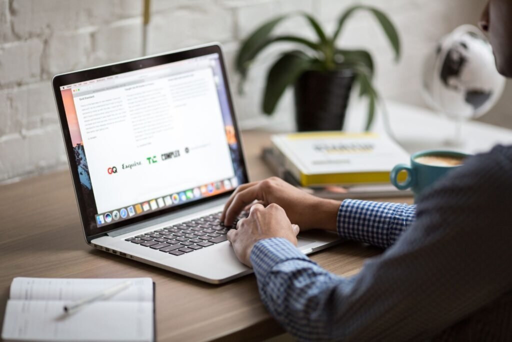 Hands typing on a laptop, actively managing and building email marketing campaigns for optimal results.