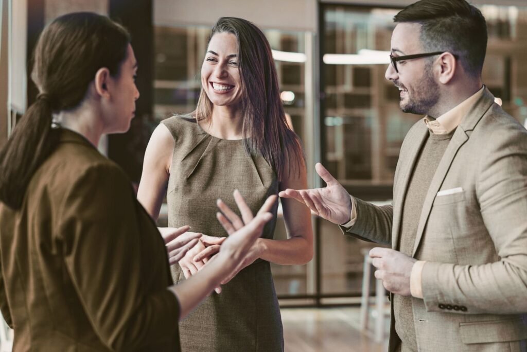 Three smiling business professionals collaborating on tailored industry-specific lead generation strategies for growth.