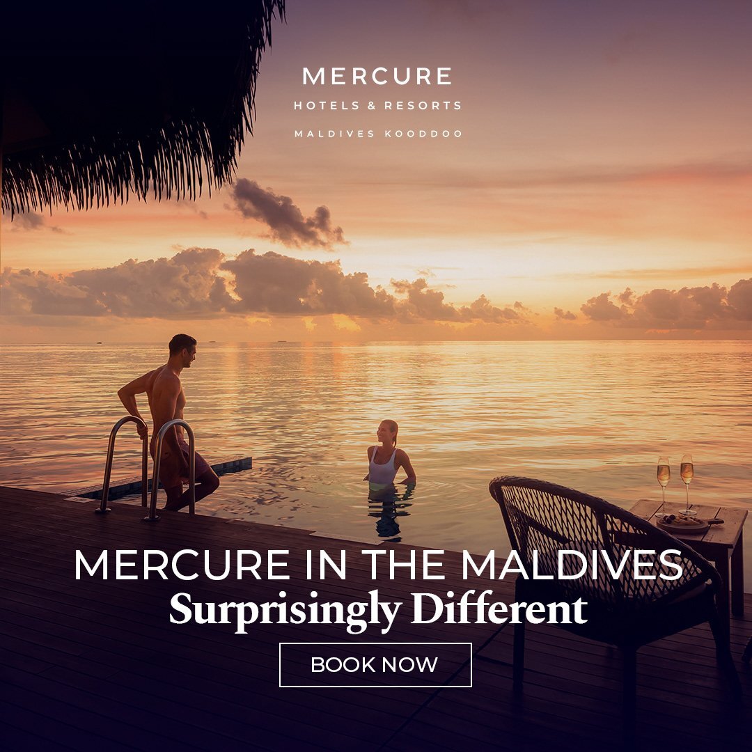 Romantic sunset at a luxury Mercure resort, with a couple enjoying the water and champagne on a deck, illustrating premium hospitality experiences.