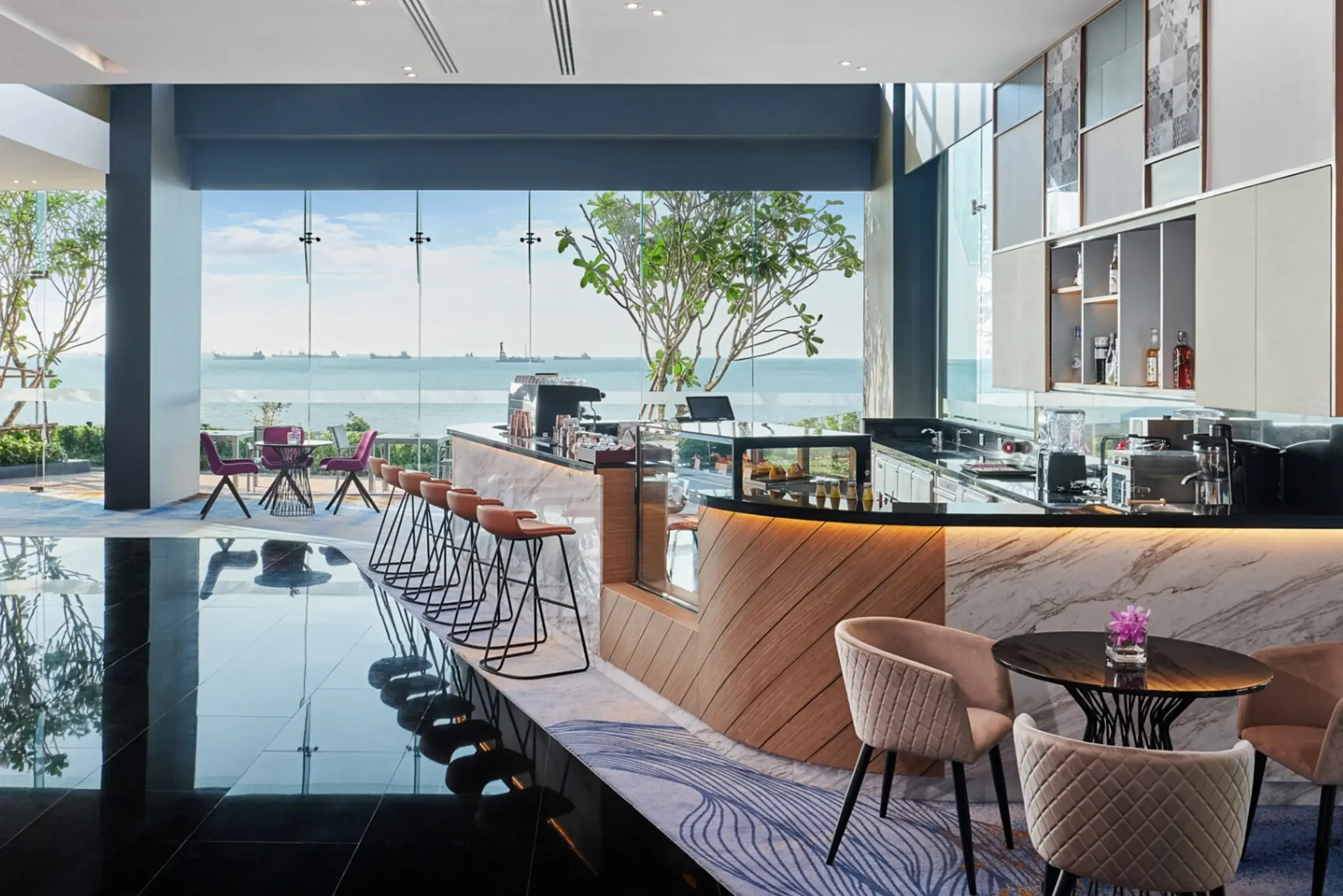 Luxurious hotel bar and restaurant overlooking the ocean in Thailand, a hospitality business benefiting from digital marketing.