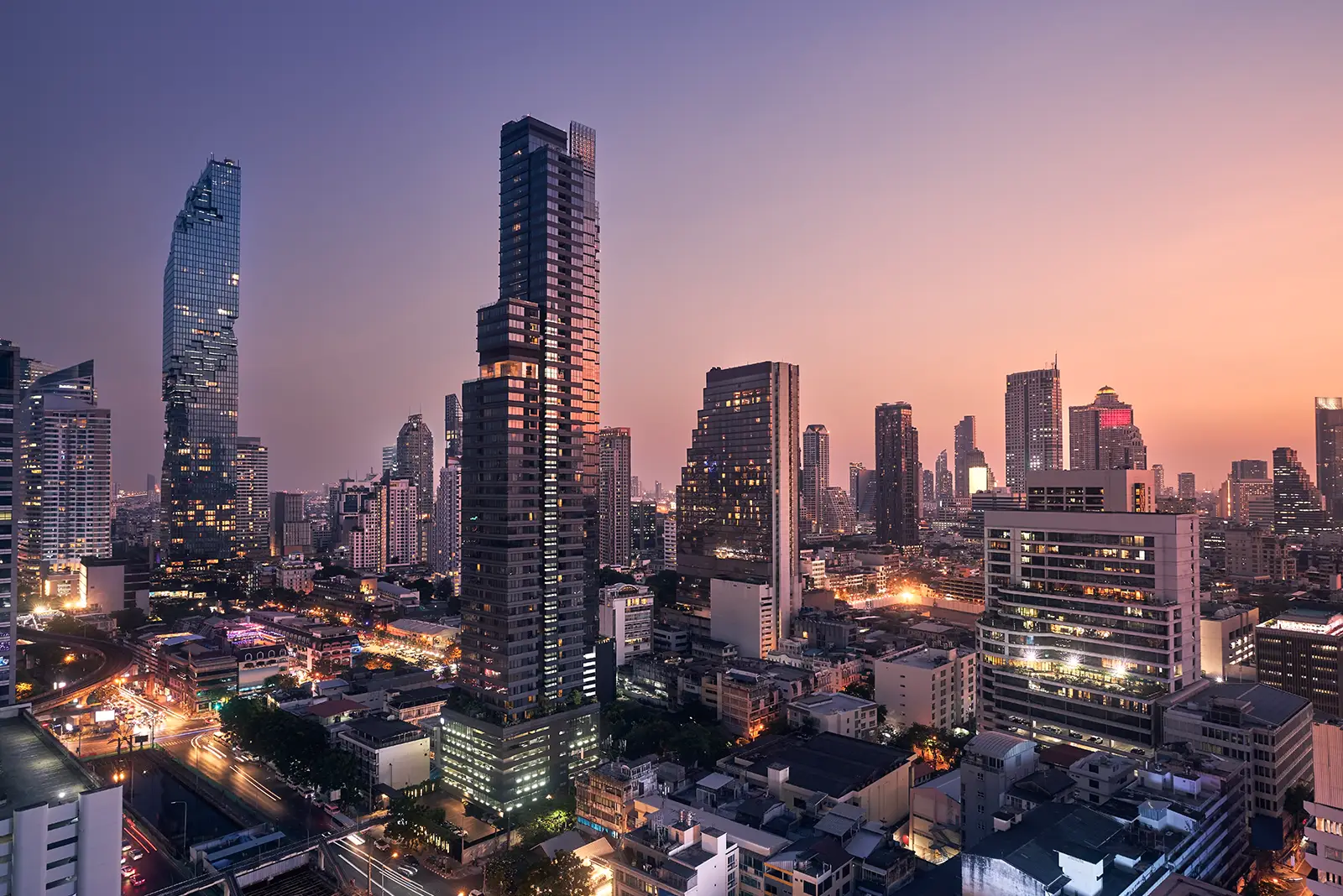 Vibrant cityscape at twilight with illuminated skyscrapers and active streets, reflecting the impact of successful digital marketing strategies.