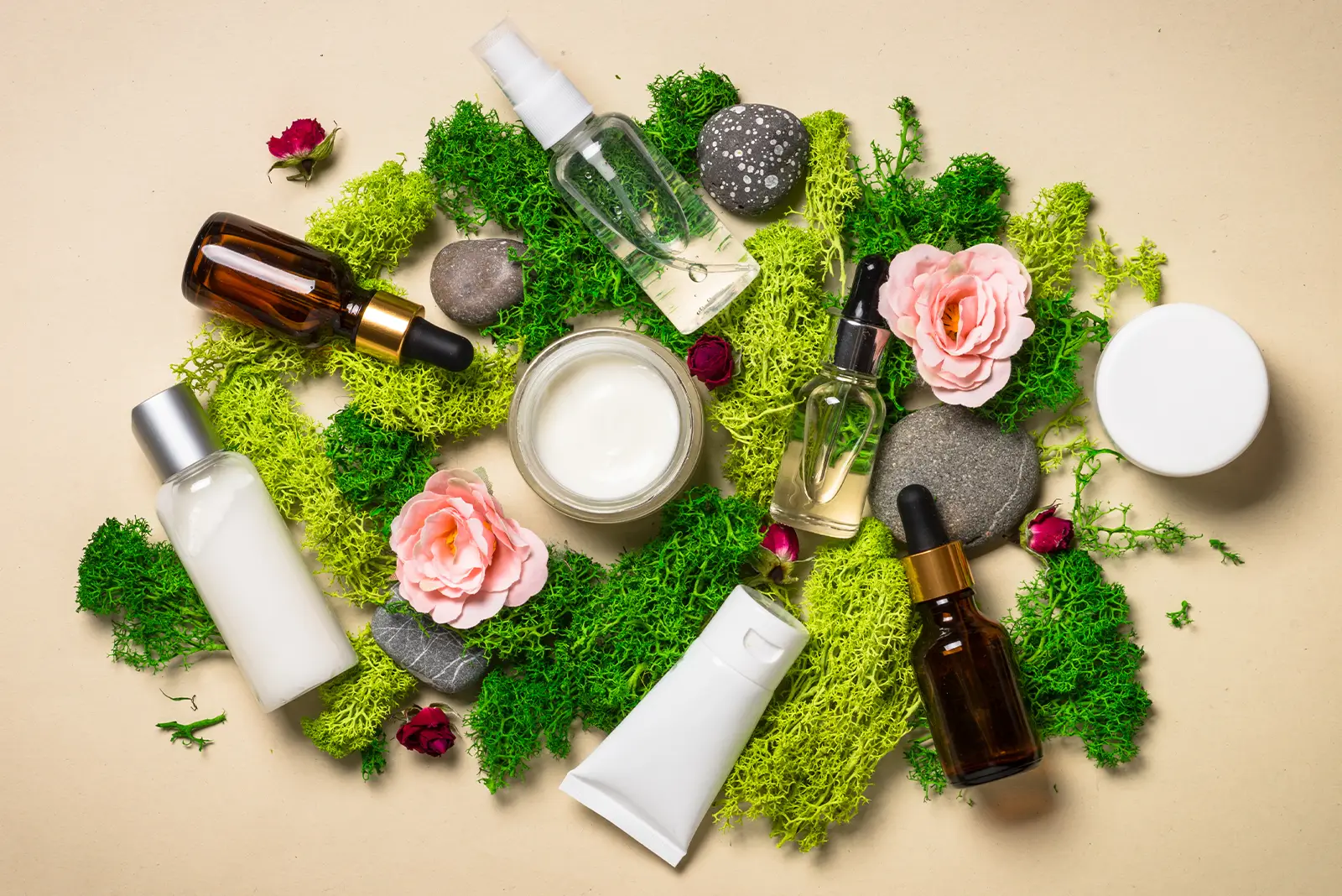 Organic beauty products, including serums and creams, on moss, showcasing Goodganic's digital marketing success.